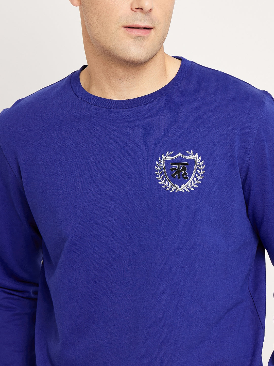 Lively Blue Sweatshirt with Radiant Crest Design